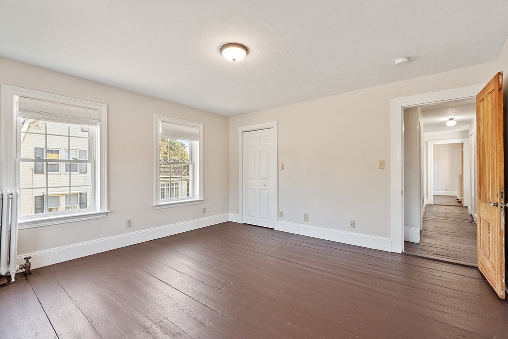 64 Central Street Gardner, MA 01440 - Photo 29 of 42 an empty room with wooden floor and windows