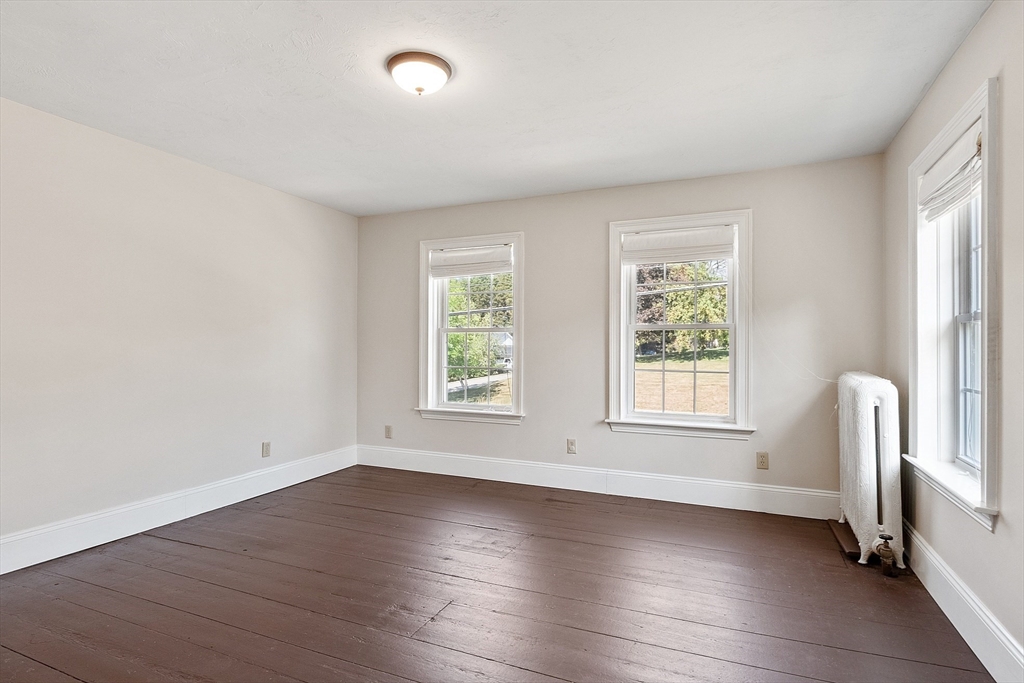 64 Central Street Gardner, MA 01440 - Photo 30 of 42 an empty room with wooden floor and windows