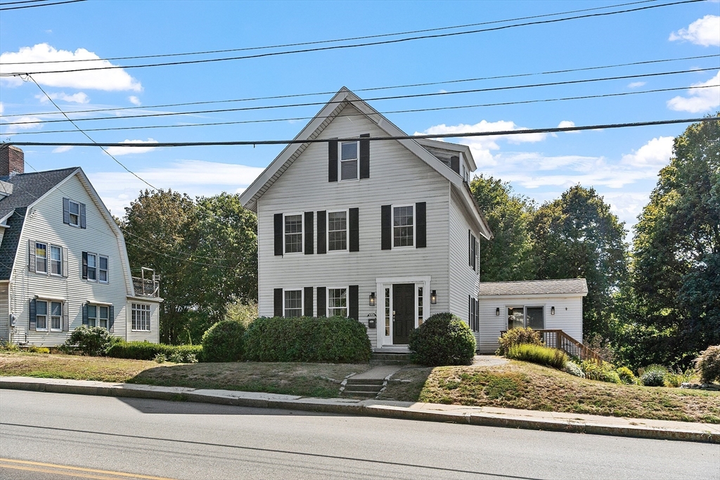 64 Central Street Gardner, MA 01440 - Photo 3 of 42 a front view of a house with garden