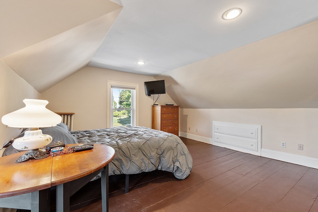 64 Central Street Gardner, MA 01440 - Photo 38 of 42 a bedroom with a bed and a lamp on table