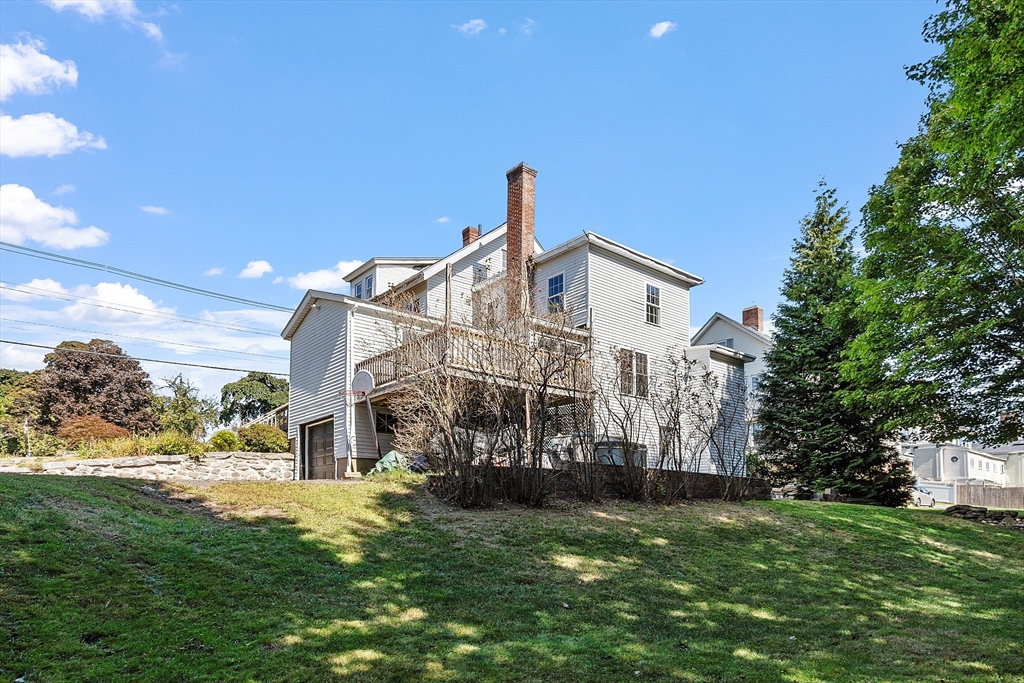 64 Central Street Gardner, MA 01440 - Photo 5 of 42 a front view of a house with a yard