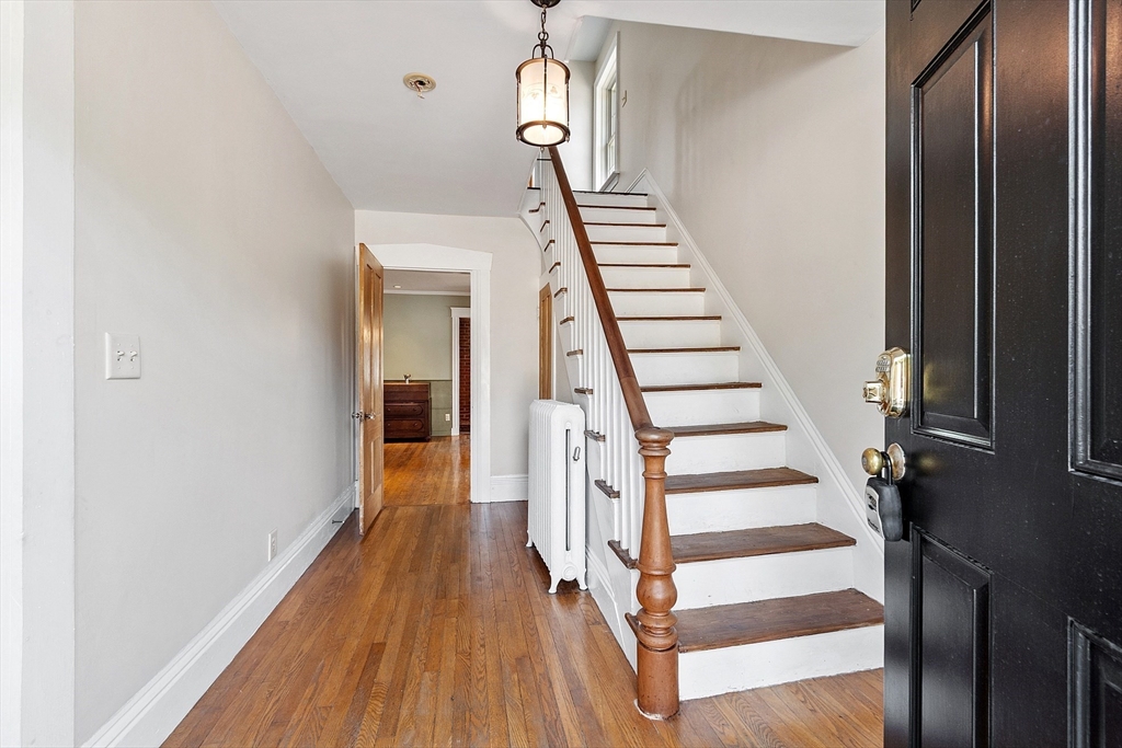 64 Central Street Gardner, MA 01440 - Photo 7 of 42 a view of a hallway with wooden floor and stairs