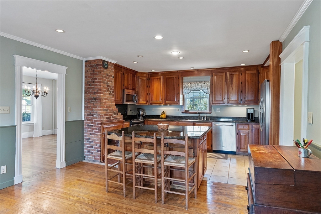 64 Central Street Gardner, MA 01440 - Photo 10 of 42 a kitchen with stainless steel appliances kitchen island granite countertop wooden cabinets and a refrigerator