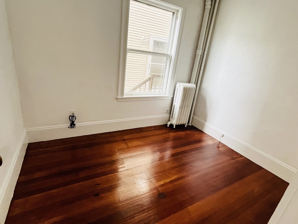 19 Beach Road, Unit 1 Winthrop, MA 02152 - Photo 6 of 9 a view of a room with wooden floor and a window
