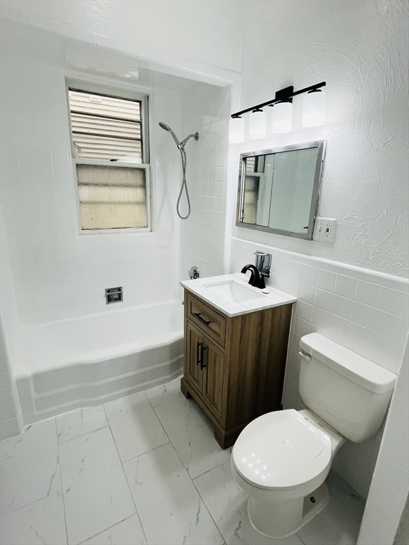 19 Beach Road, Unit 1 Winthrop, MA 02152 - Photo 9 of 9 a bathroom with a toilet a sink and mirror