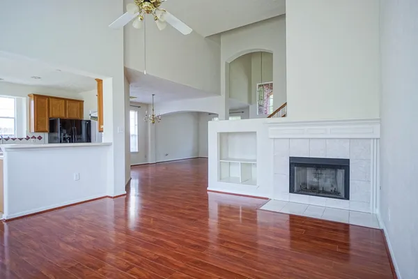 a view of an empty room with a fireplace and a window