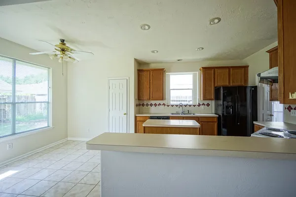 a kitchen with a refrigerator and a sink