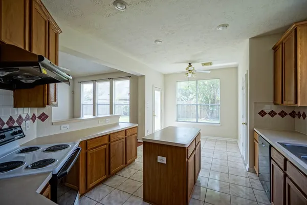 a kitchen with a sink stove and cabinets