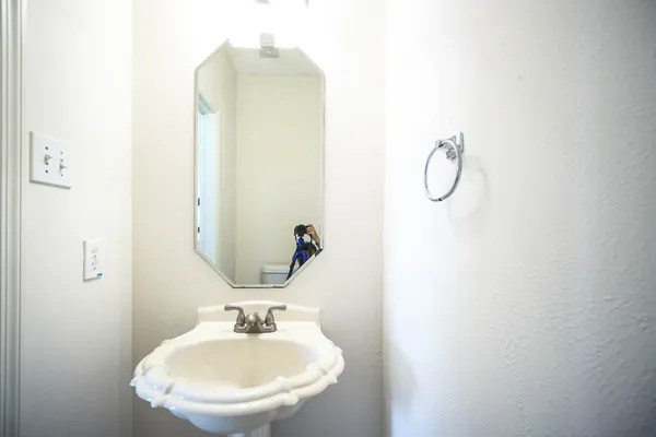 a bathroom with a sink and mirror