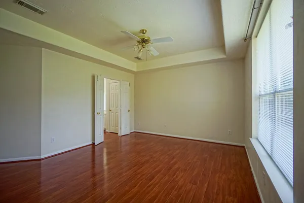 wooden floor in an empty room with a window