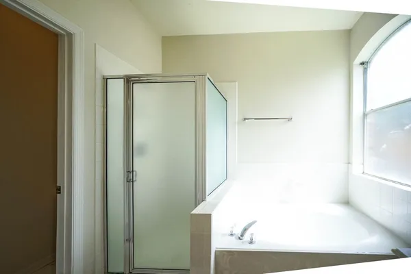 a bathroom with a bathtub and a shower