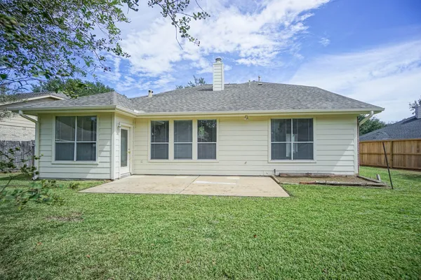 a front view of a house with a garden and yard