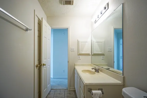 a bathroom with a sink mirror toilet and shower