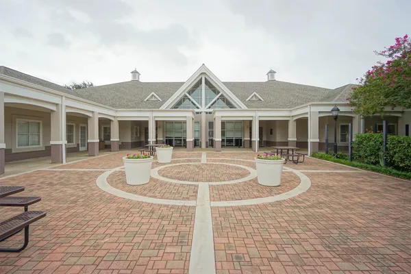 a front view of a house with yard and green space