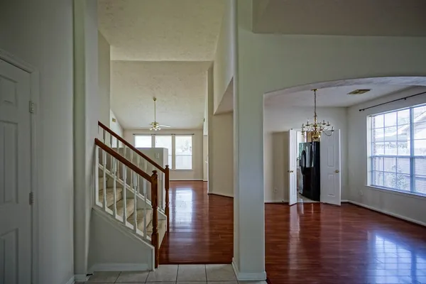 a view of an entryway with wooden floor and stairs