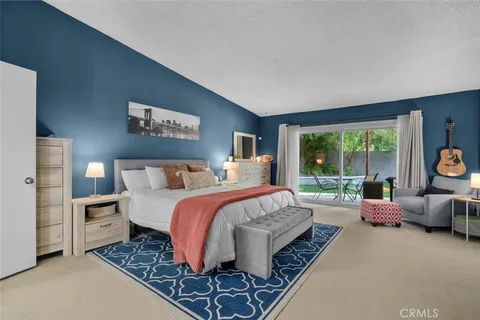 a bed room with bed and a large window