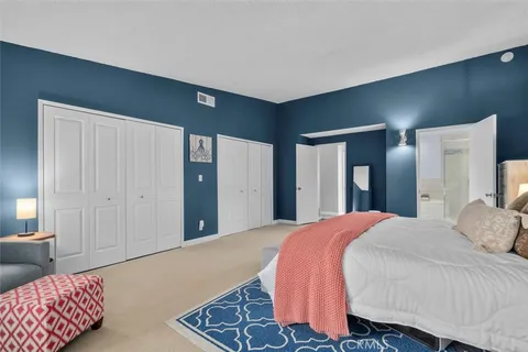 a bedroom with a bed and a couch