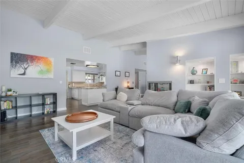 a living room with furniture a rug and a table