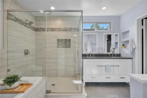 a bathroom with a shower sink and mirror