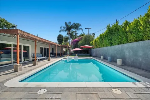 swimming pool view with a seating space