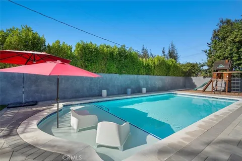 a backyard of a house with table and chairs