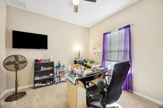 a view of a livingroom with furniture and a flat screen tv
