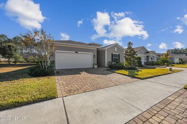 a view of the house with swimming pool and wooden fence