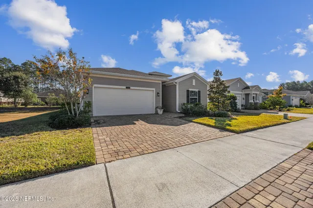 a view of the house with swimming pool and wooden fence