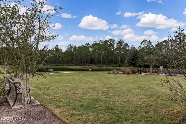 an aerial view of a house with a yard basket ball court and outdoor seating