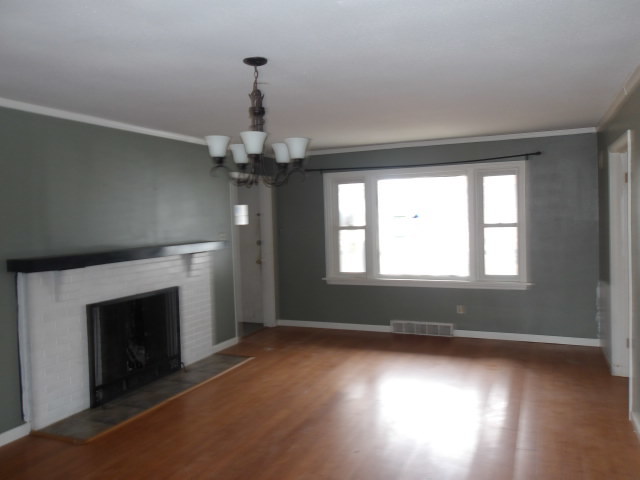 13 Southern Drive Decatur, IL 62521 - Photo 2 of 29 wooden floor in an empty room with a window