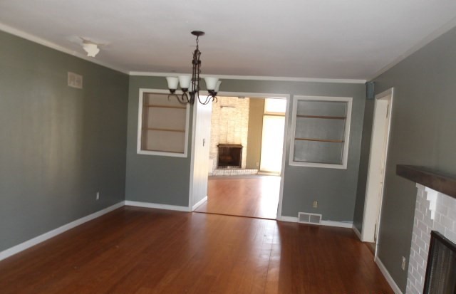 13 Southern Drive Decatur, IL 62521 - Photo 3 of 29 an empty room with wooden floor and windows