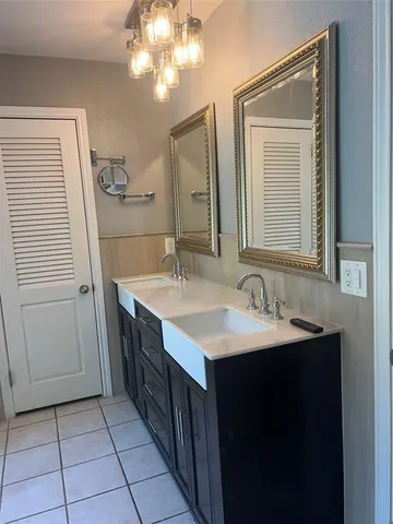 a bathroom with a sink a mirror and a vanity