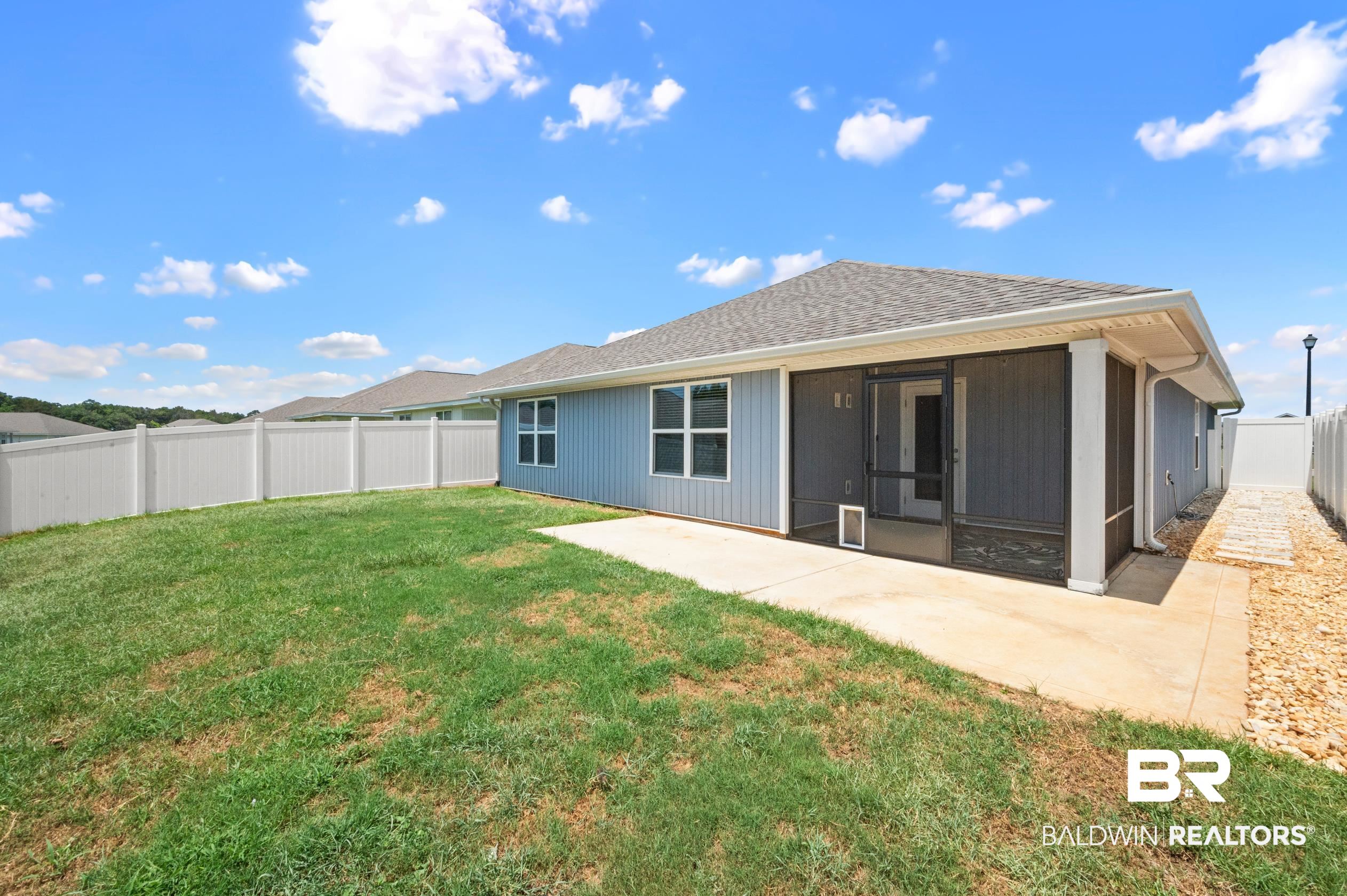 10353 Zenyatta Loop Daphne, AL 36526 - Photo 31 of 33 Back of property featuring a sunroom and a yard