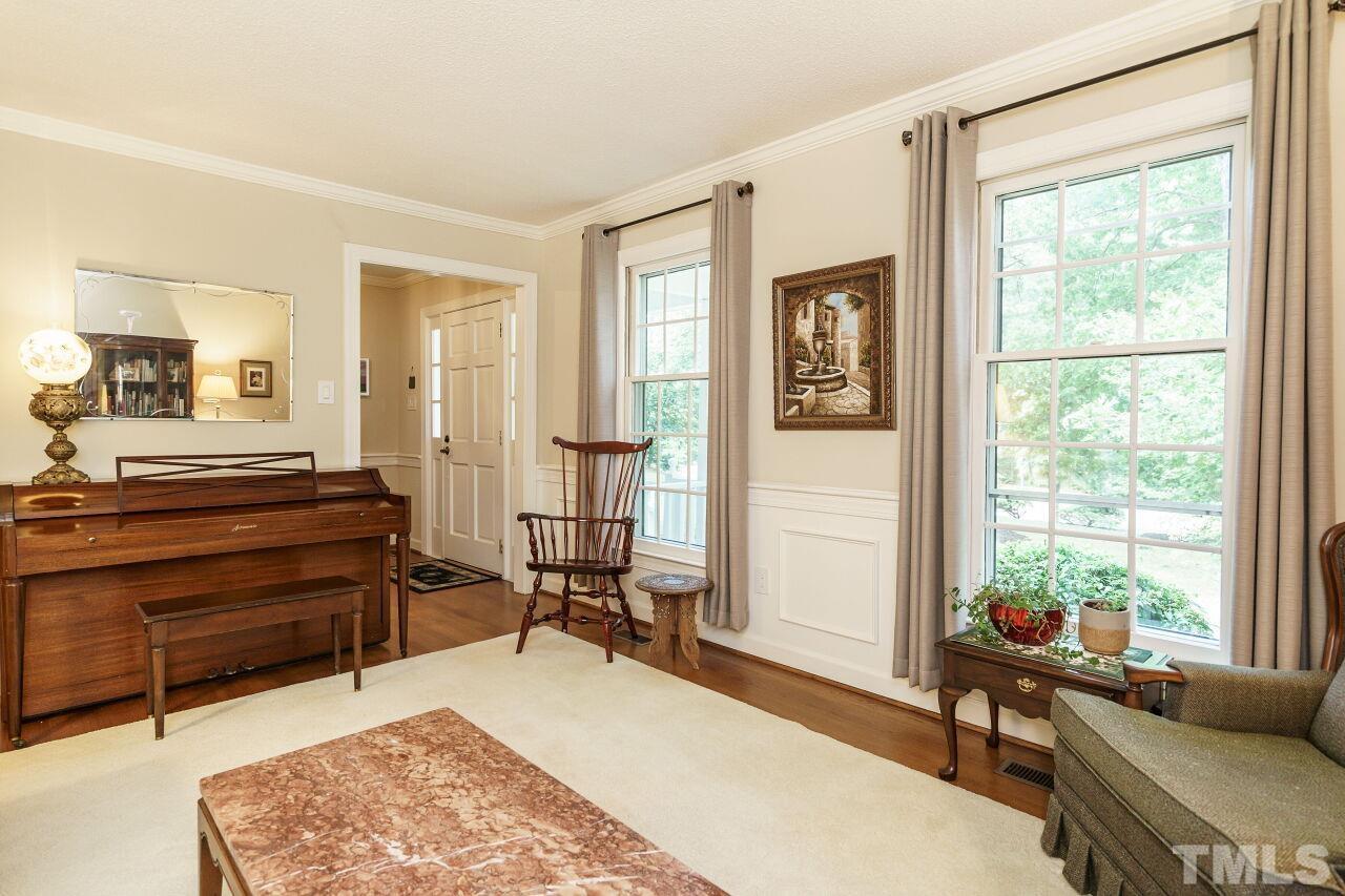 8116 Calais Court Raleigh, NC 27613 - Photo 3 of 33 a living room with a couch dresser and large window