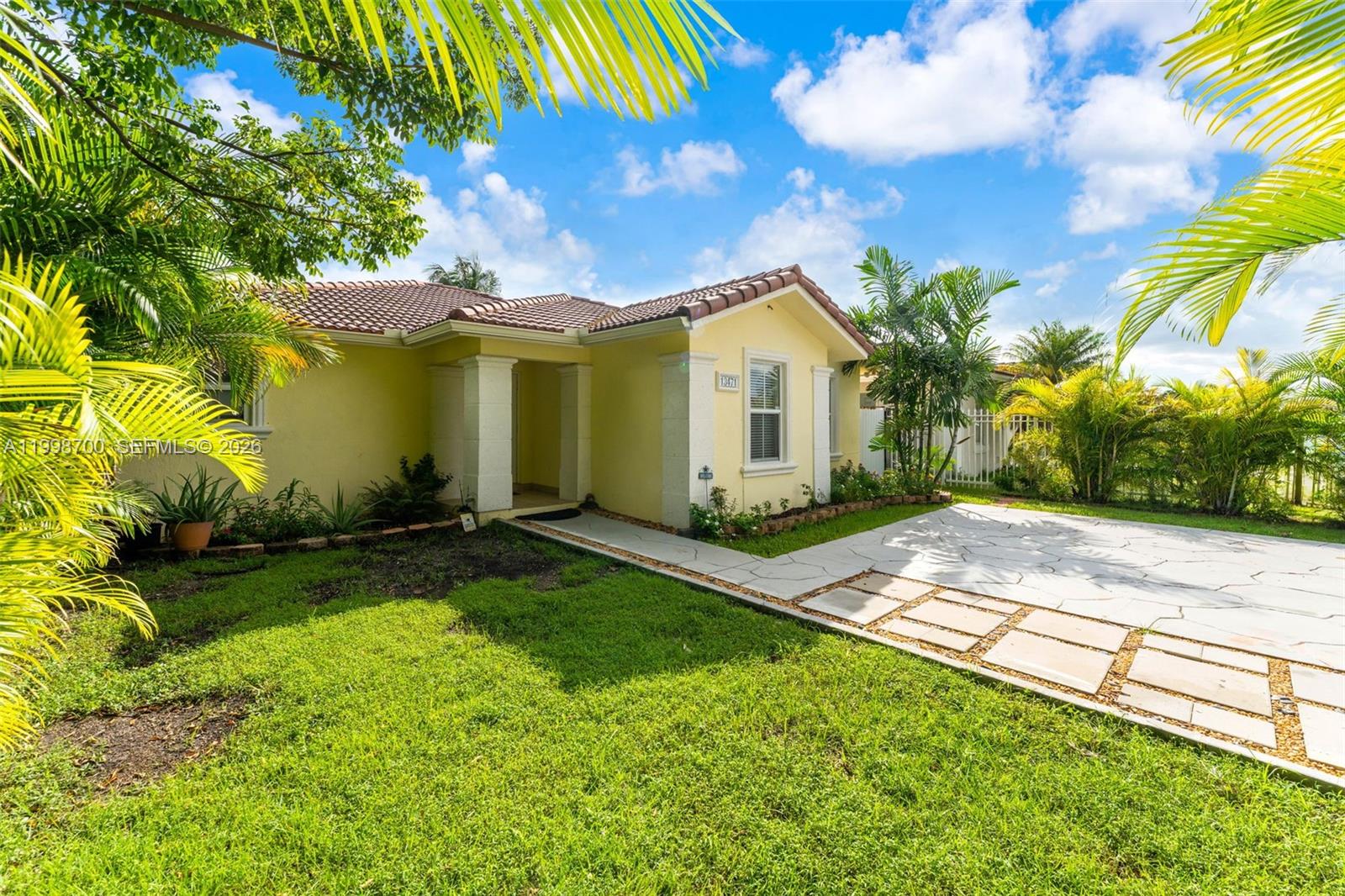 13471 Southwest 278th Terrace Homestead, FL 33032 - Photo 1 of 32 a view of a house with a yard and palm trees