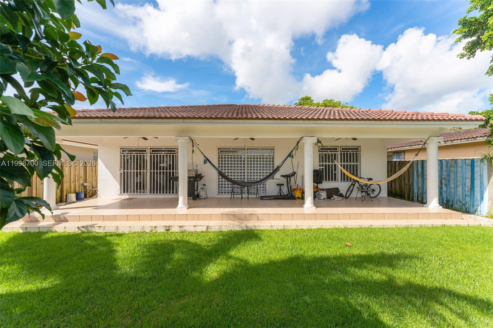 13471 Southwest 278th Terrace Homestead, FL 33032 - Photo 11 of 32 front view of a house with a yard