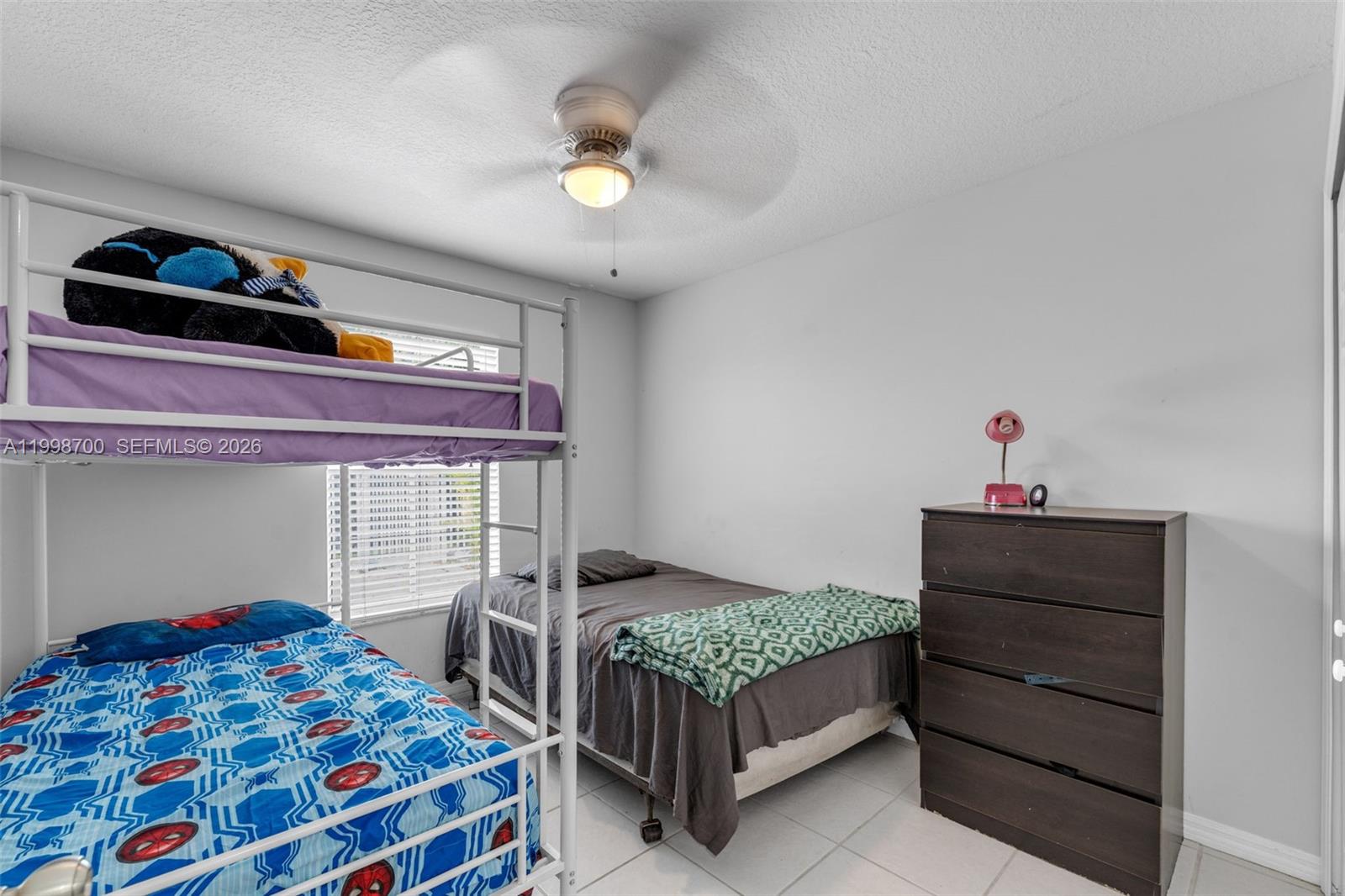 13471 Southwest 278th Terrace Homestead, FL 33032 - Photo 17 of 32 a bedroom with a bed and a dresser