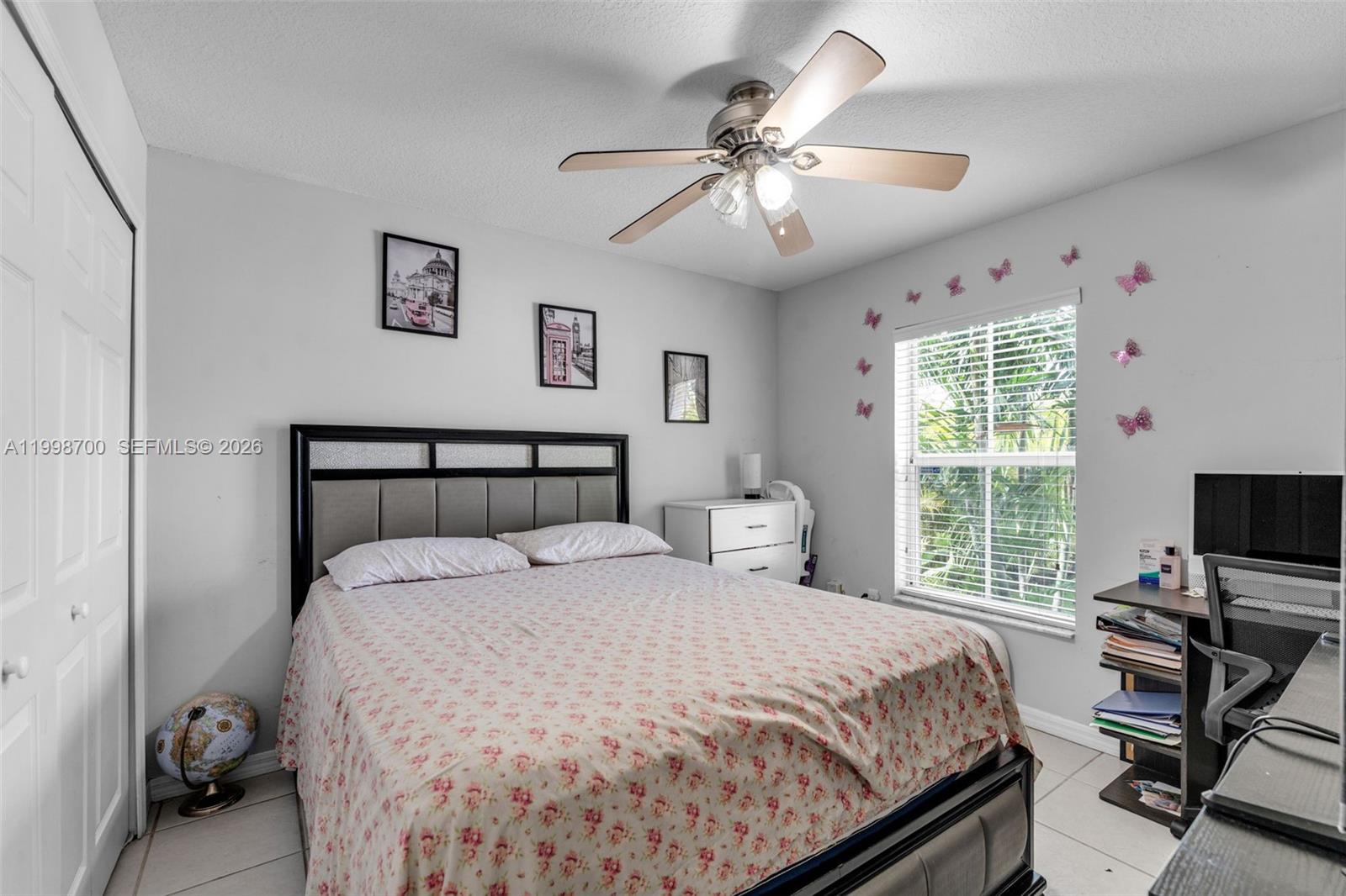 13471 Southwest 278th Terrace Homestead, FL 33032 - Photo 18 of 32 a bedroom with a bed and a flat screen tv