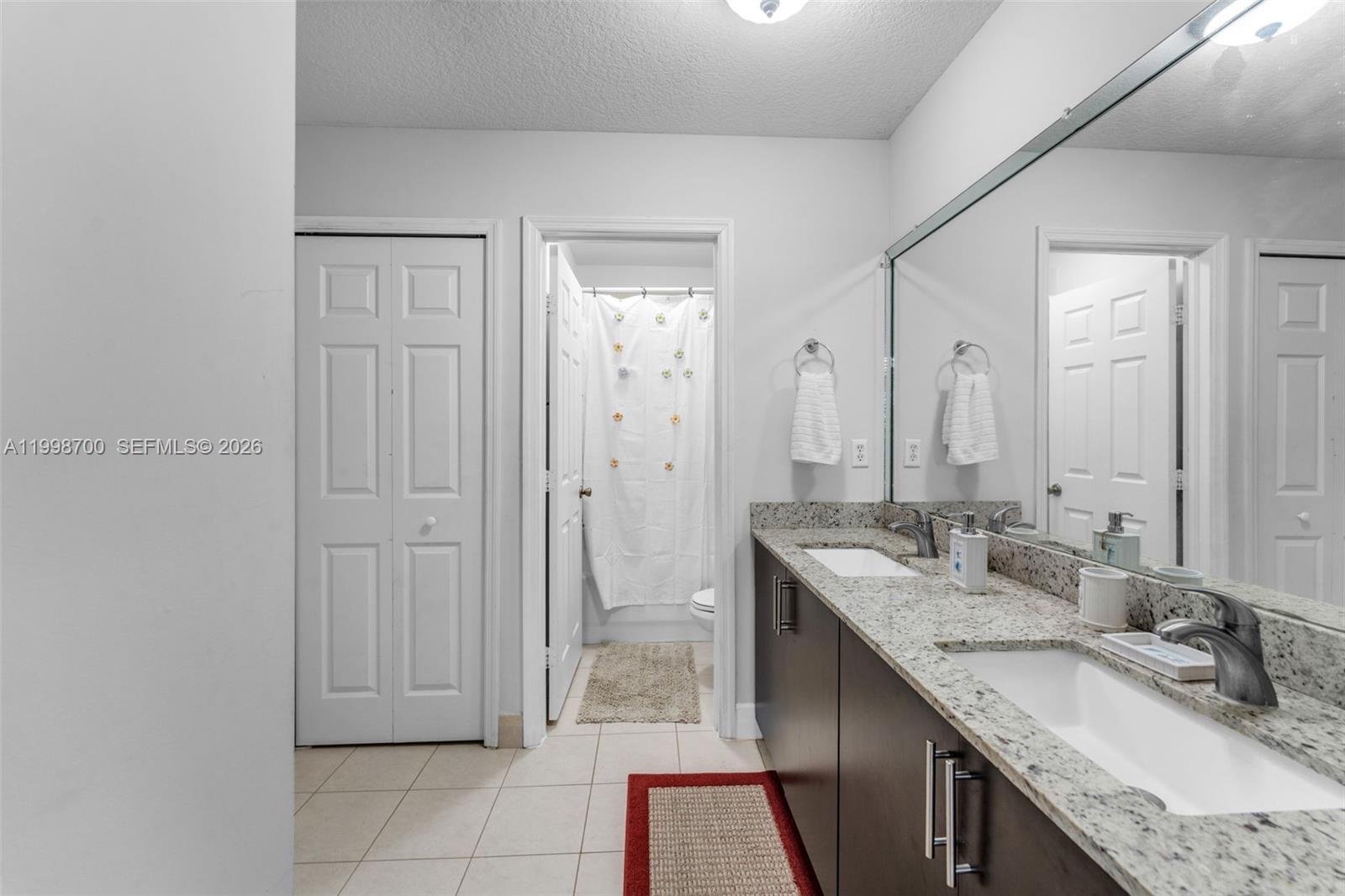 13471 Southwest 278th Terrace Homestead, FL 33032 - Photo 20 of 32 a bathroom with a granite countertop sink and a mirror