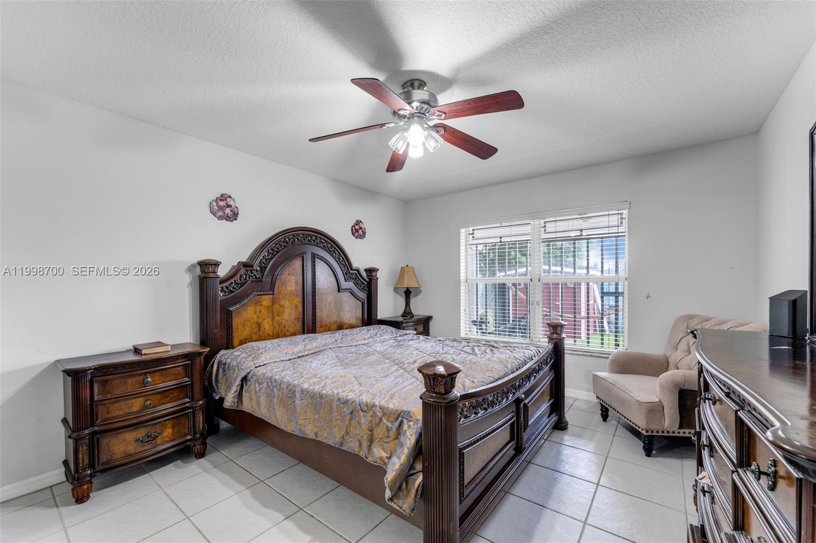 13471 Southwest 278th Terrace Homestead, FL 33032 - Photo 22 of 32 a bedroom with a bed and a chandelier