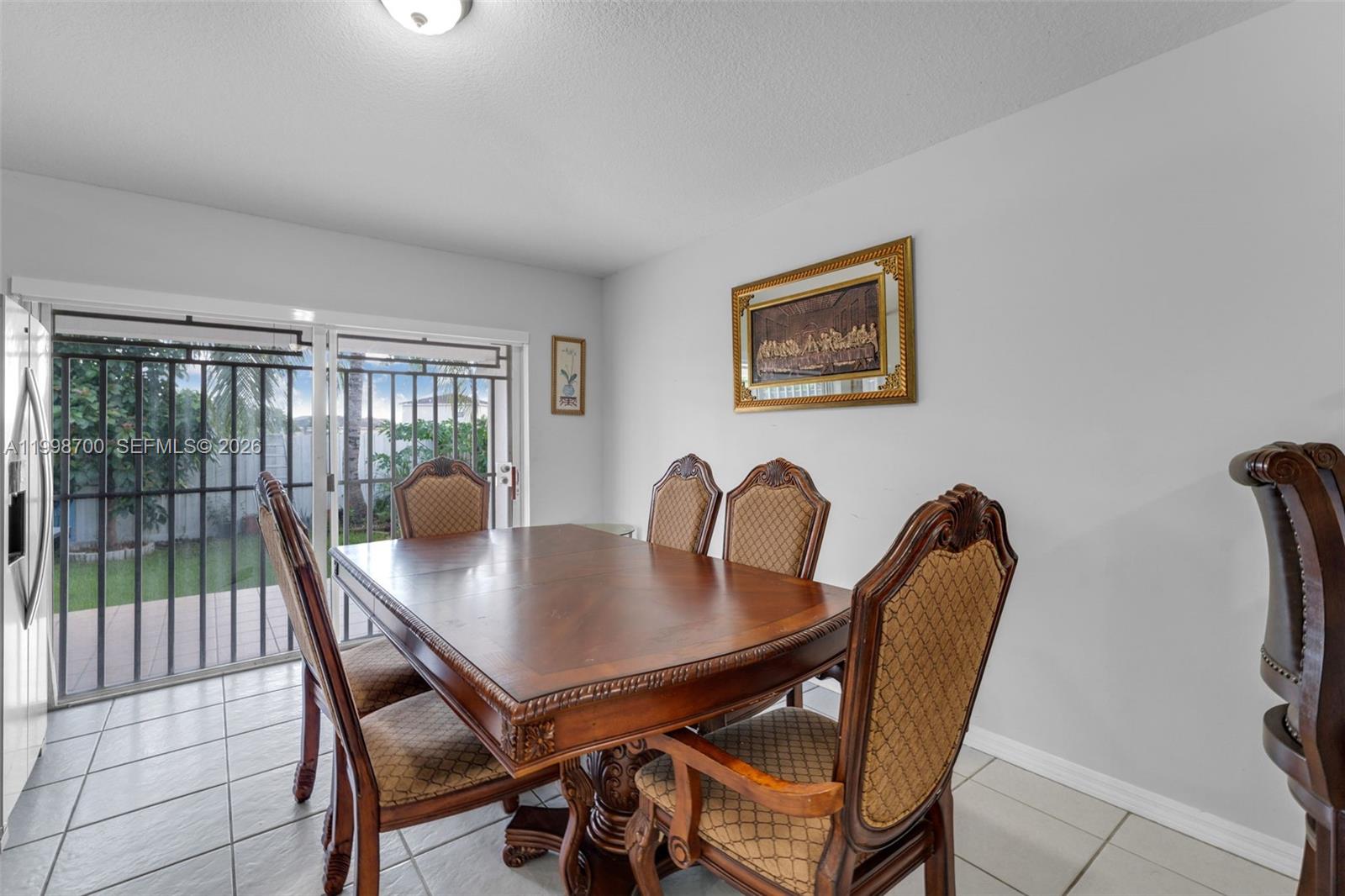 13471 Southwest 278th Terrace Homestead, FL 33032 - Photo 24 of 32 a view of a dining room with furniture and wooden floor