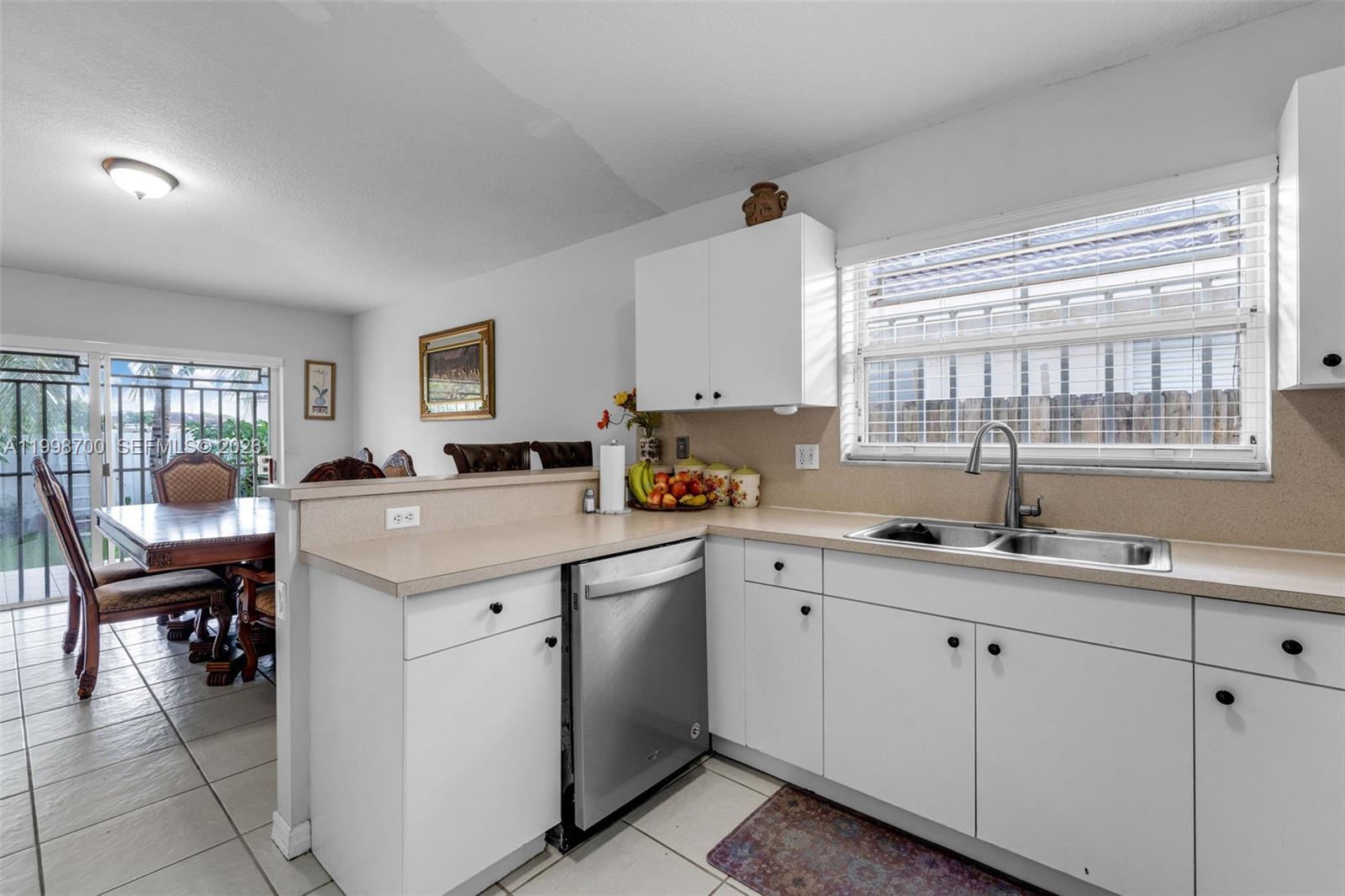 13471 Southwest 278th Terrace Homestead, FL 33032 - Photo 25 of 32 a kitchen with a sink stove and cabinets