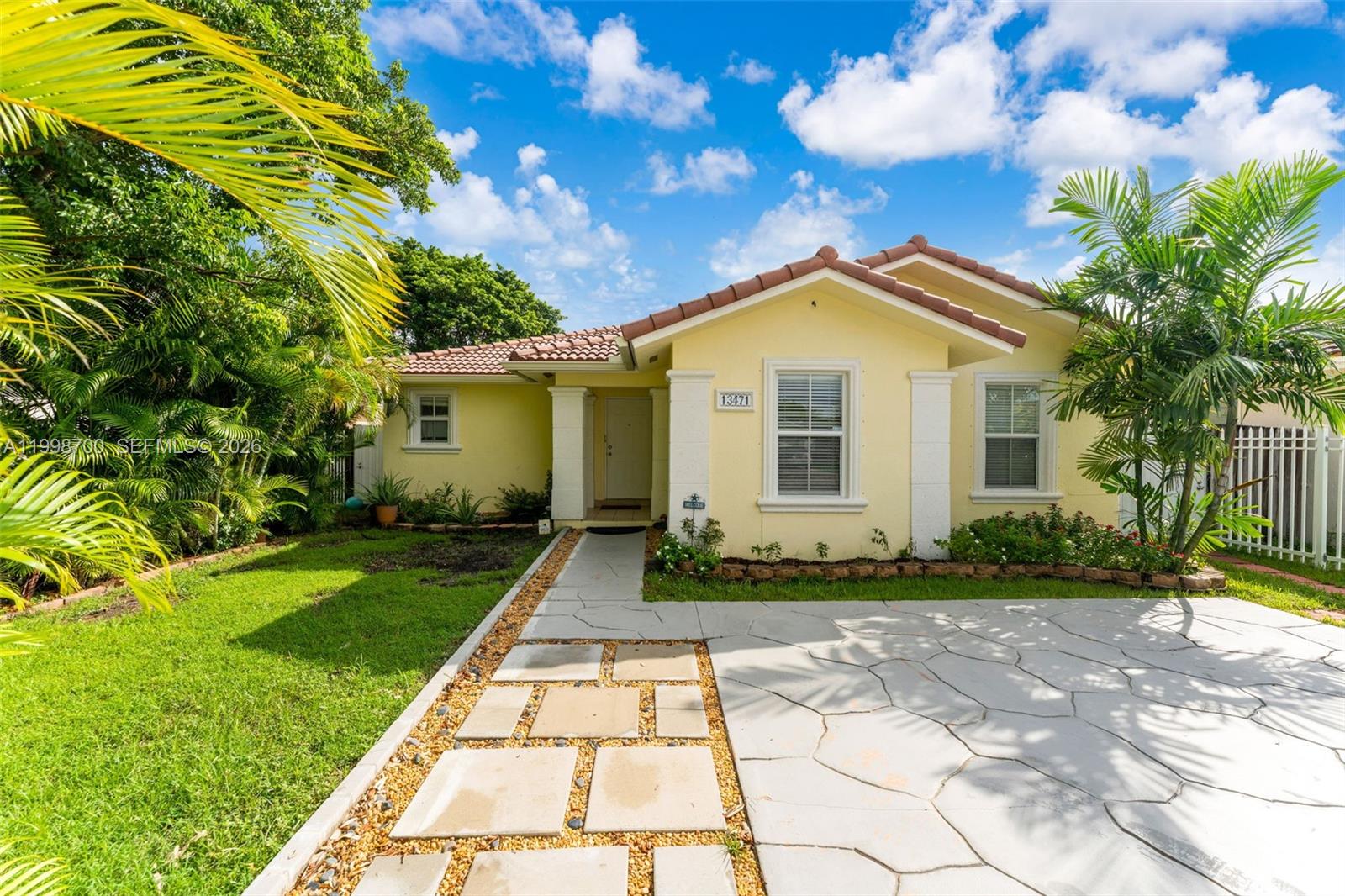 13471 Southwest 278th Terrace Homestead, FL 33032 - Photo 3 of 32 a view of a yard in front of a house with a large tree