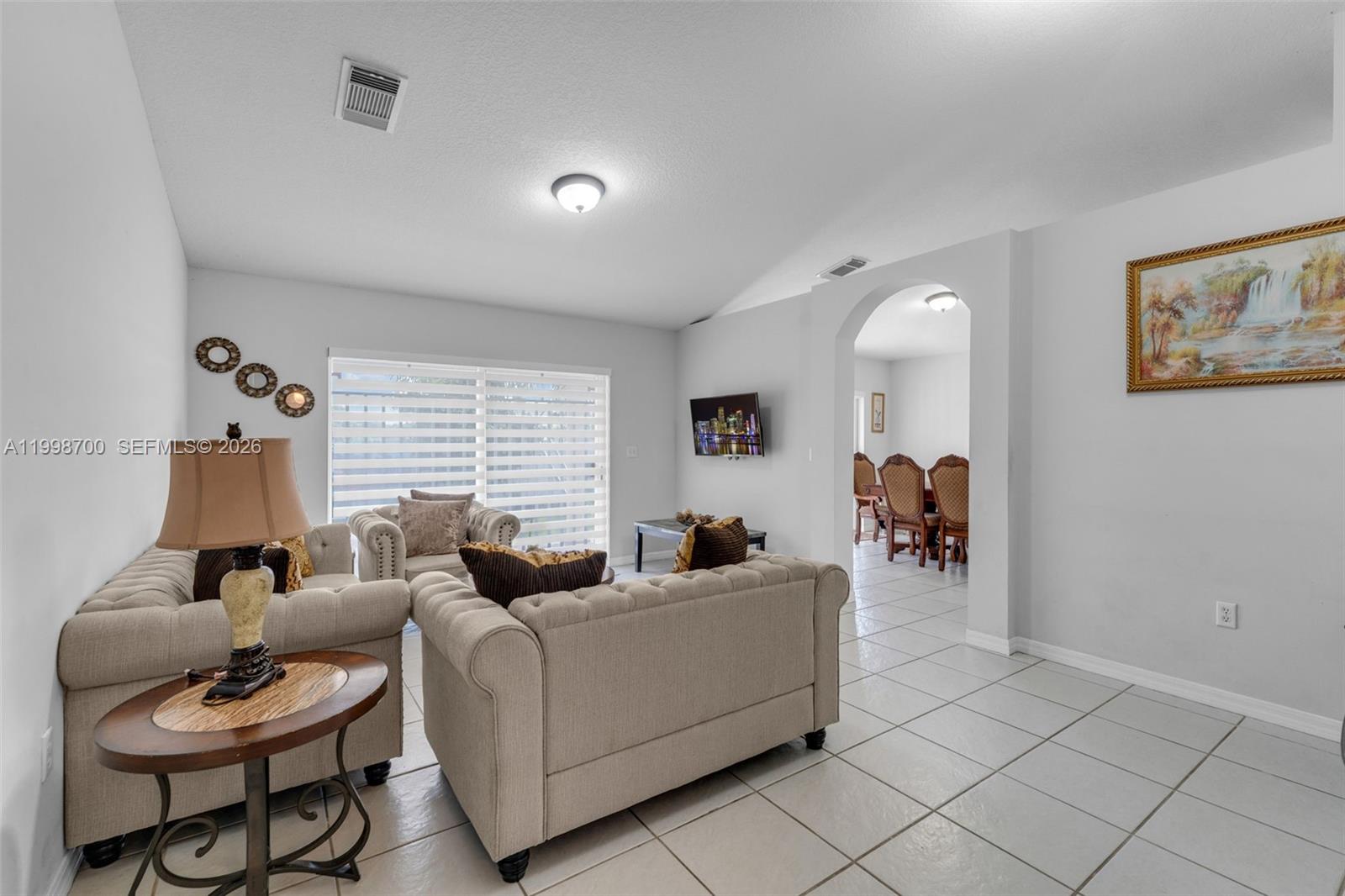 13471 Southwest 278th Terrace Homestead, FL 33032 - Photo 31 of 32 a living room with furniture and a wooden floor