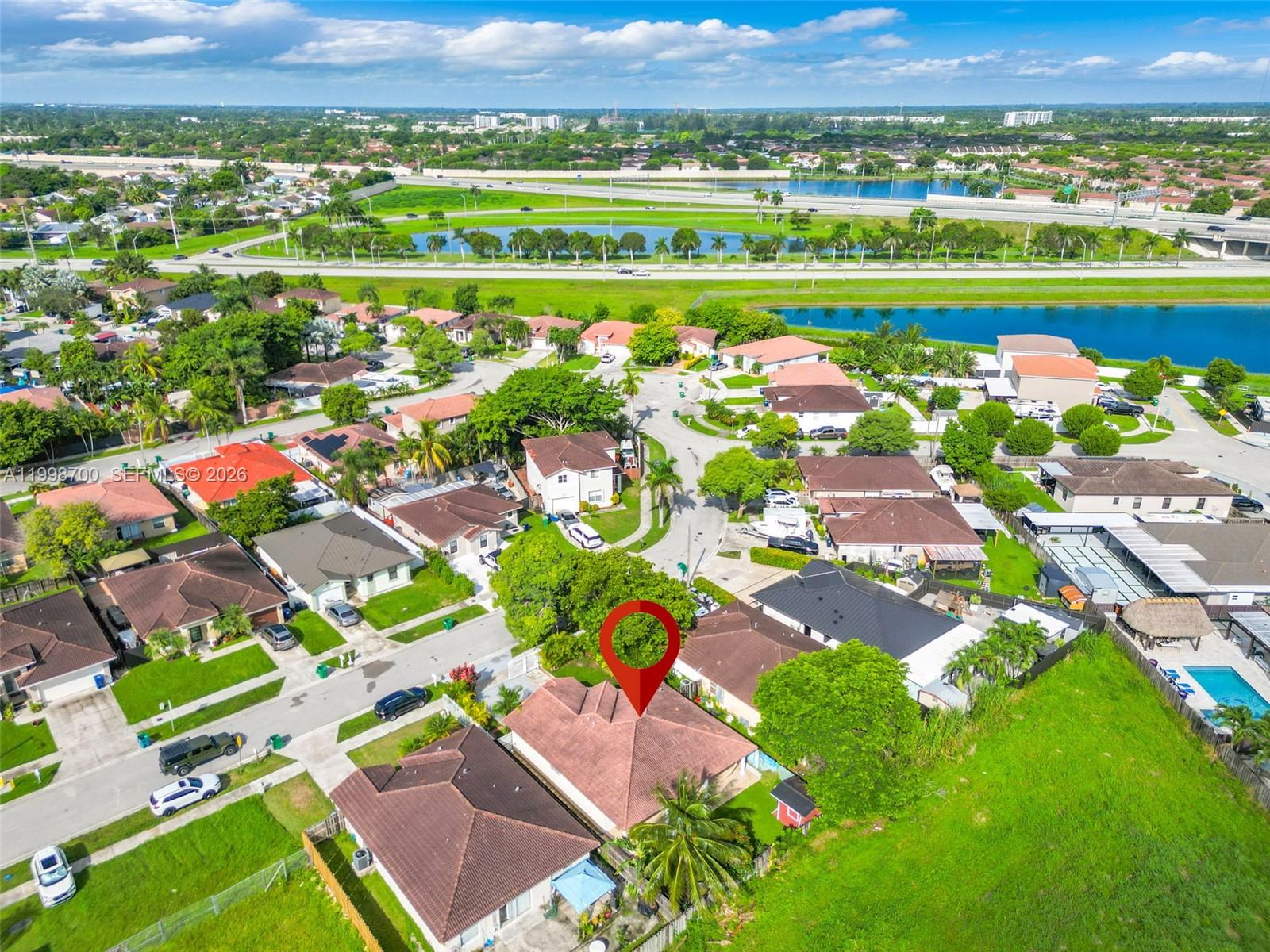 13471 Southwest 278th Terrace Homestead, FL 33032 - Photo 7 of 32 an aerial view of a city with lots of residential buildings ocean and mountain view in back
