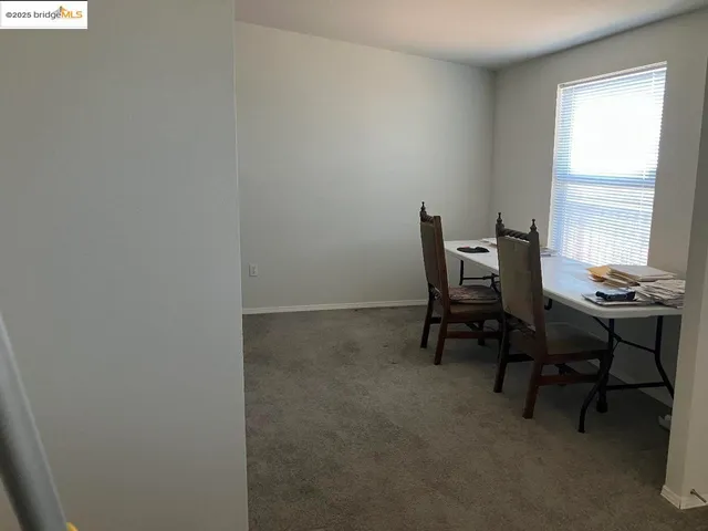 a workspace room with furniture and a window