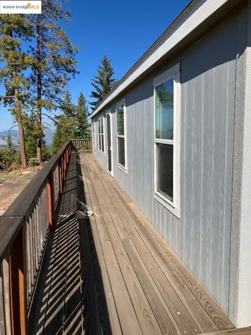 a view of a house with backyard and deck