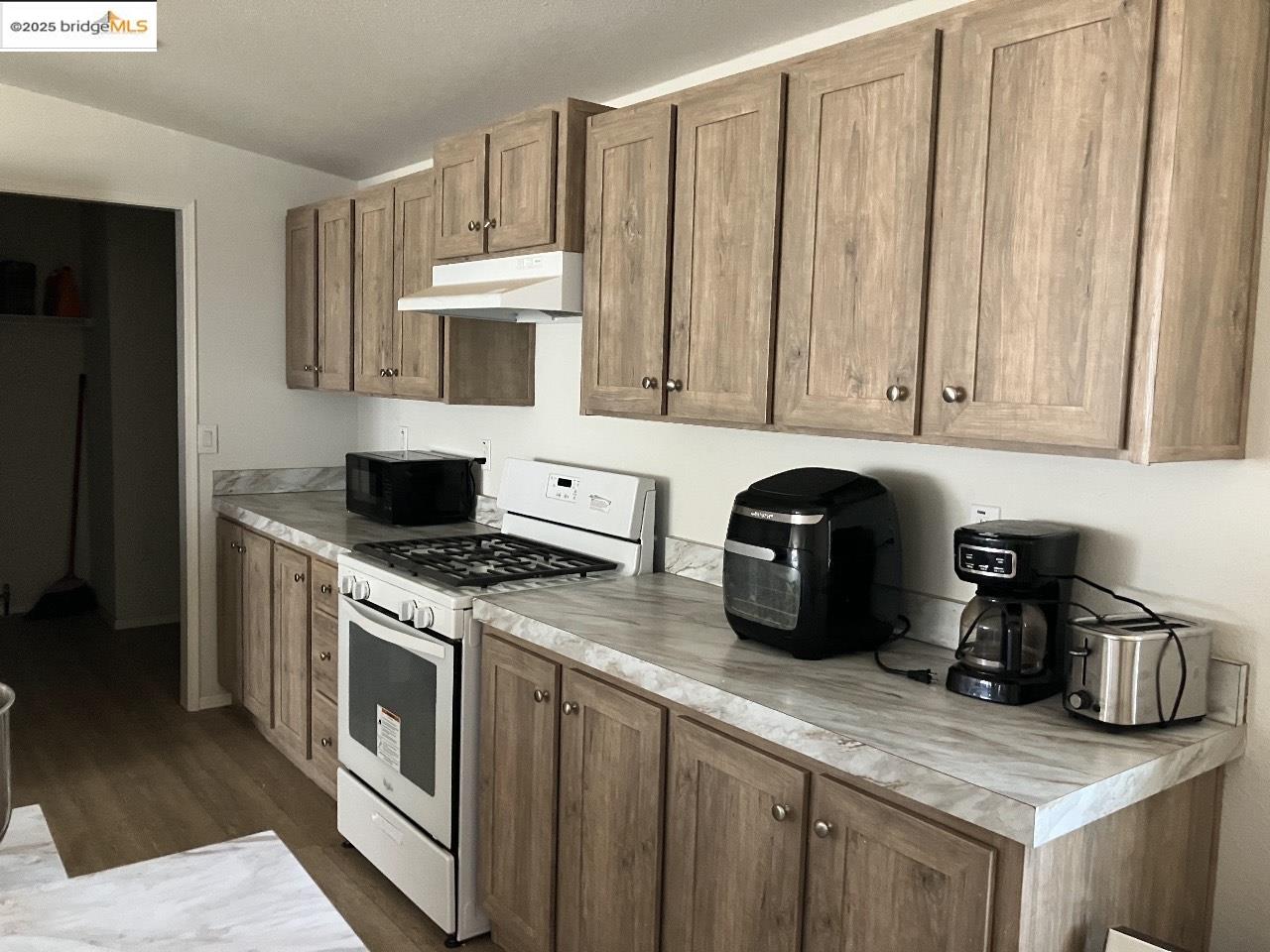 1000 2nd Garrotte Ridge Road Groveland, CA 95321 - Photo 7 of 20 a kitchen with stainless steel appliances granite countertop a stove a sink and a white cabinets