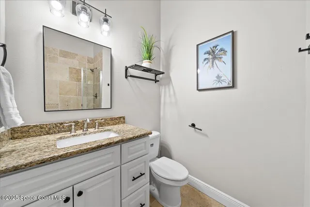 a bathroom with a toilet a sink and a mirror