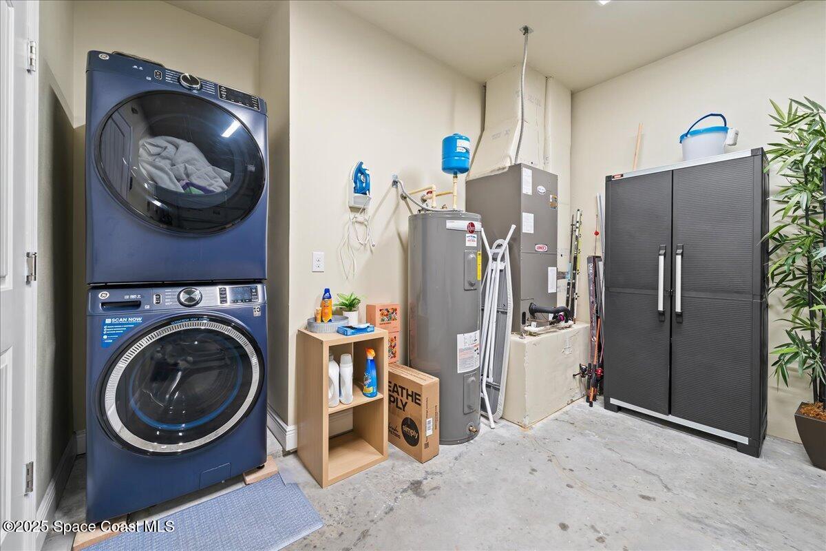 2730 Cutlass Point Lane, Unit 101 Merritt Island, FL 32953 - Photo 20 of 31 a view of a refrigerator and washer in a kitchen